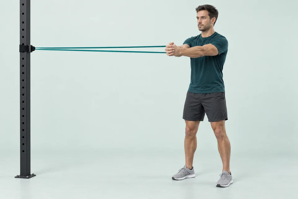 Pallof press with both arms extended forward and a resistance band pulling sideways from a chest-height anchor.